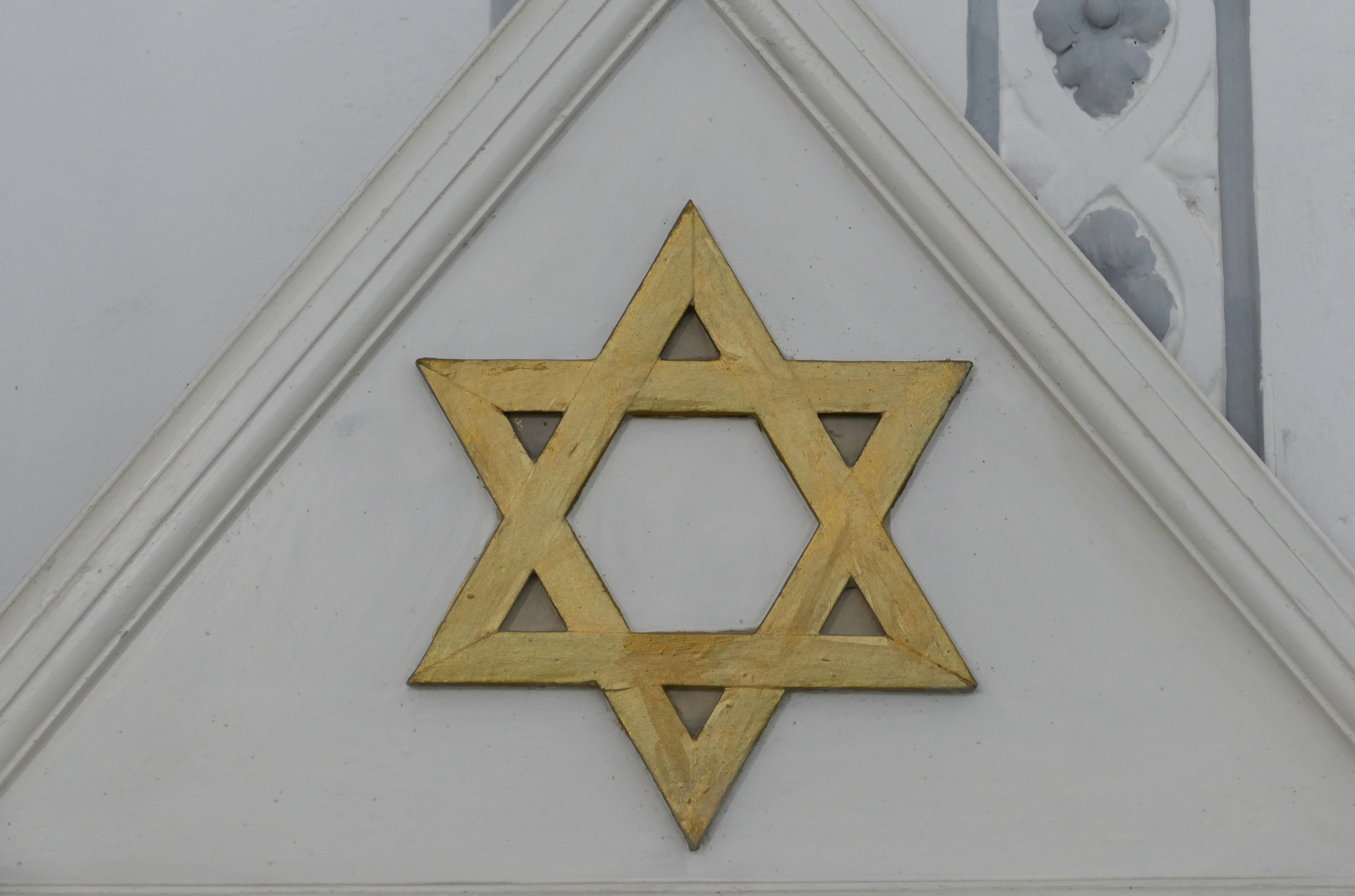 Zu sehen ist ein goldener Judenstern auf einer Fassade